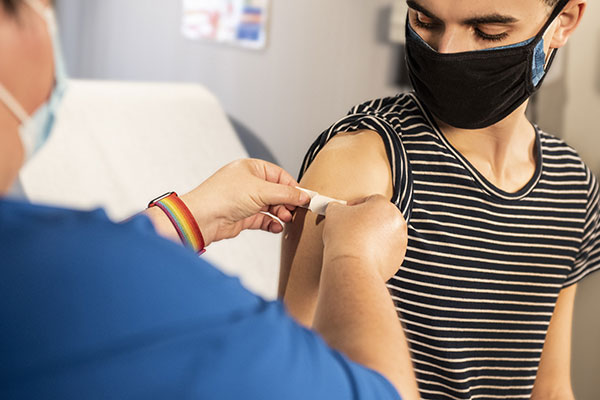 Person receiving vaccination in their arm