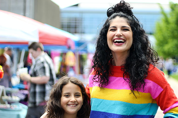 woman wearing rainbow sweater at pride event