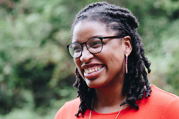 black woman wearing glasses and smiling