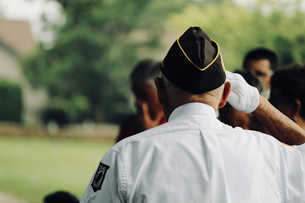 an elderly veteran salutes