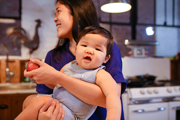 young woman carrying a baby