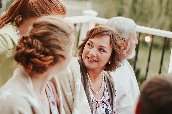 Family sitting on the porch smiling