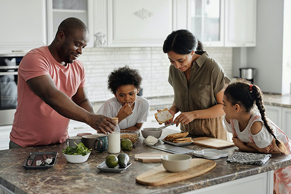 family cooking dinner around the kitchen island