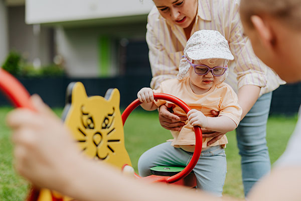 child and family playing with outdoor equipment