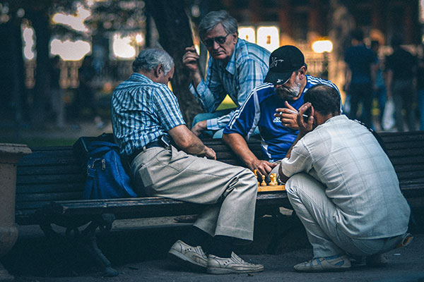 elderly men playing chess