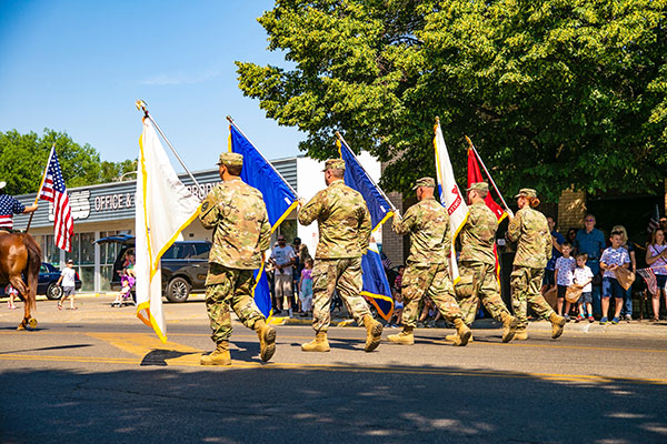 military service members carry flags
